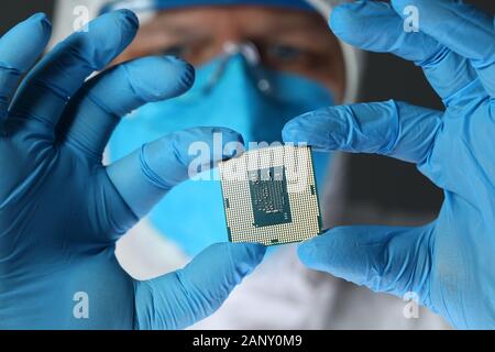 Close up of computer microchip in male hands Stock Photo