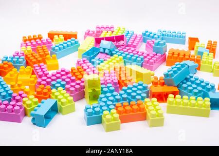 multi colored blocks of a children designer scattered on a white background. Stock Photo