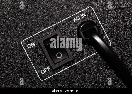 The panel of the household appliance with the power cord and switch, closeup. Stock Photo