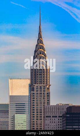 New York, USA - August 1, 2019: Aerial view of the Chrysler building skyscraper in the iconic skyline in Midtown Manhattan against a blue sky Stock Photo