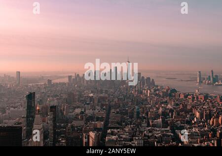 Cotton candy pink and purple sunrise of the Manhattan New York City skyline taken from the Empire State Building observation deck Stock Photo