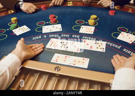 Hands of players and croupiers in the game cards. Stock Photo