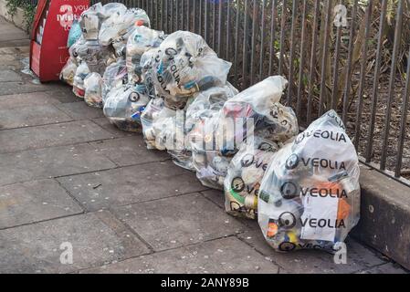 London, UK - Jan 16, 2020:  Bags of rubbish on the footpath in the City of London ready to be collected Stock Photo
