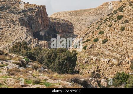 an ancient byzantine monastery clings to the side of a cliff in the ein prat reserve in wadi qelt in the west bank of israel and palestine Stock Photo