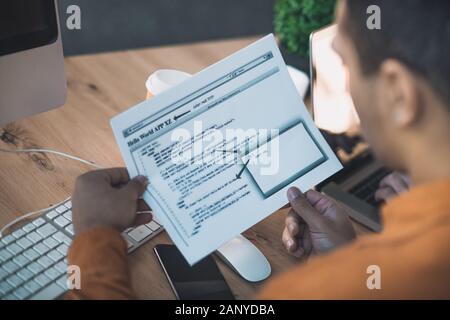 Top view of programming code written on paper Stock Photo