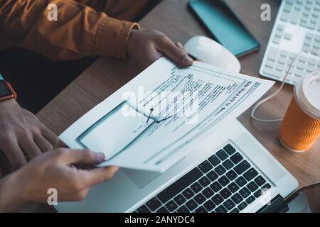 Sheet of paper being in male hands Stock Photo