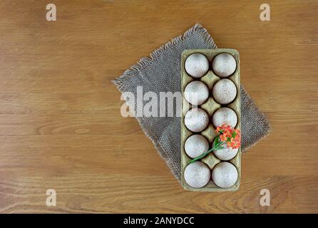 Turkey eggs in pressed paper packaging. Wood background. Easter concept. Flat lay. Copy spase. Stock Photo