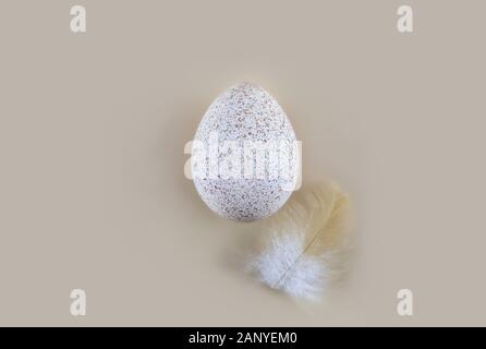 One turkey egg on a light background. Easter concept. Minimalist style. Flat lay. Copy spase. Stock Photo
