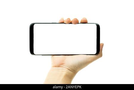 Woman hand holding black mobile phone with white screen at the background, smartphone blank screen Stock Photo