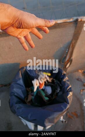 throw the garbage in dustbin Stock Photo