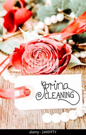 One Label With English Calligraphy Spring Cleaning. Rose Flower, Pearl On Wooden Background Stock Photo