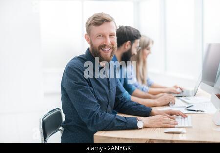 successful young man in the workplace in the office Stock Photo