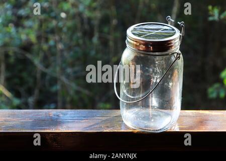 Closeup shot of an empty glass jar on a wooden surface Stock Photo