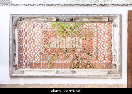 Chinese traditional style lattice window in the garden,Fuzhou,Fujian,China.Through the window the trees in the yard can be seen. Stock Photo