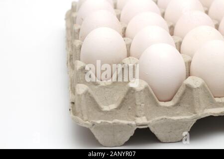 Isolated recycle tray with white eggs on a white background. Tray without one egg Stock Photo