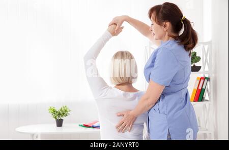 Picture of middle aged woman during rehabilitation in professional clinic. Closeup Stock Photo