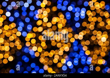 Vivid blue and orange circles, abstract festive background of blurred soft dots of holiday illumination bokeh Stock Photo