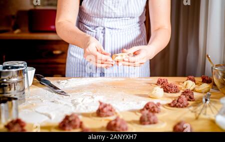 The concept of making bread, baking. Woman kneads the dough. Kneading the dough Stock Photo