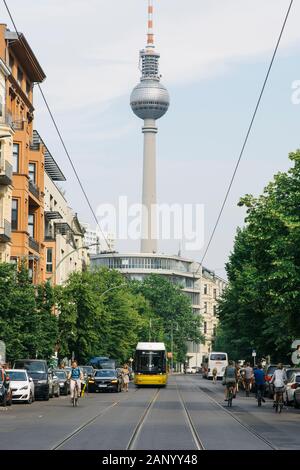 BERLIN, GERMANY - MAY 27, 2018: A tramcar in a street of the Mitte district of Berlin, Germany, with the Berliner Fernsehturm, the popular television Stock Photo