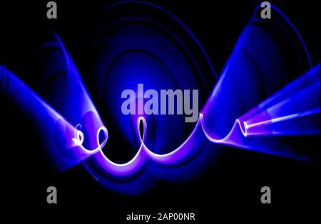 HIGH CONTRAST VIVID COLOUR ABSTRACT BACKGROUND CREATED BY LIGHT PAINTING -SCIENCE FICTION, DYNAMIC MOVEMENT,ARTISTIC MERIT. Stock Photo