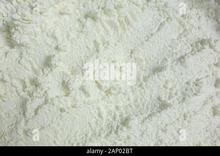 Textured white substance background. Foam consistence backdrop closeup view of ice cream, cotton cheese or snow like. Mock-up or template for design b Stock Photo
