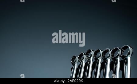 Set of chrome wrenches or spanners isolated on glass table in workshop. Chrome vanadium spanner wrench. Silver wrenches. Mechanic tools. Hardware for Stock Photo