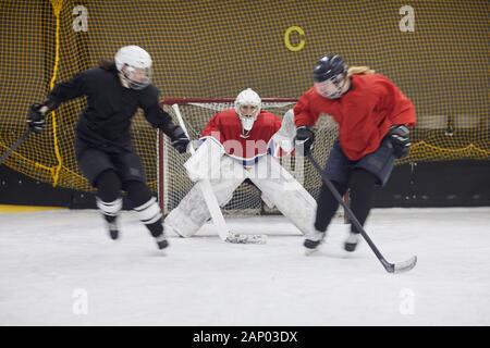 Full length action shot of female hockey team fighting during match, copy space Stock Photo