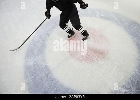 High angle action shot of hockey player running on ice in stadium, copy space Stock Photo