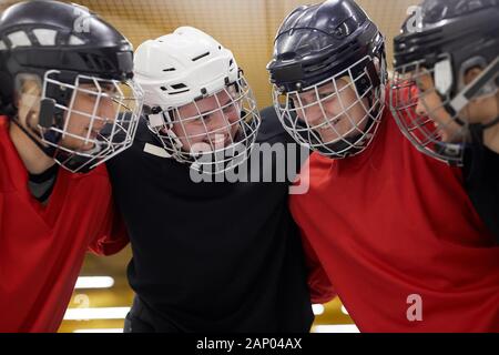 Portrait of female hockey team huddling happily before sports match, copy space Stock Photo