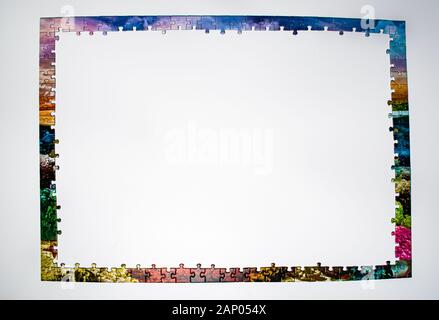 Colorful frame made from pieces of a puzzle, on white background Stock Photo