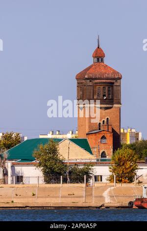 Old water-tower in river harbor. Port crane. Stock Photo