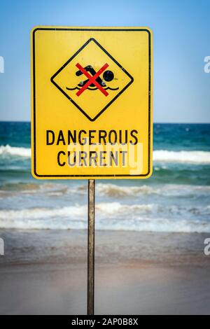 Dangerous current warning sign for swimmers at beach Stock Photo