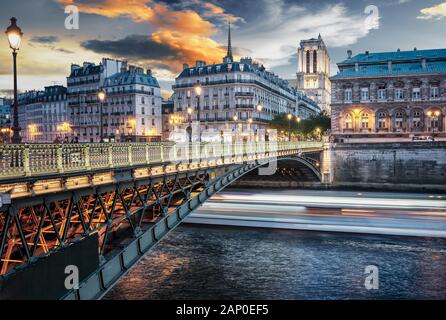 The Alexander III Bridge across Seine river in Paris, France at sunset.