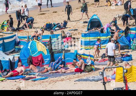 Holidaymakers enjoying themselves on Fistral Beach in Newquay in Cornwall.