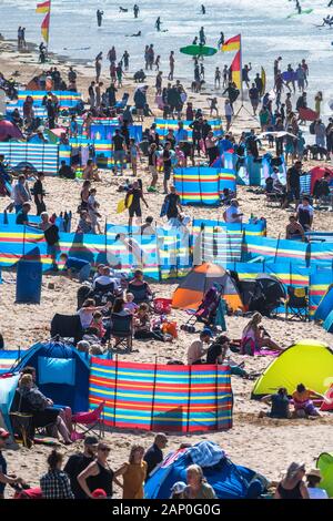 Holidaymakers enjoying themselves on Fistral Beach in Newquay in Cornwall.