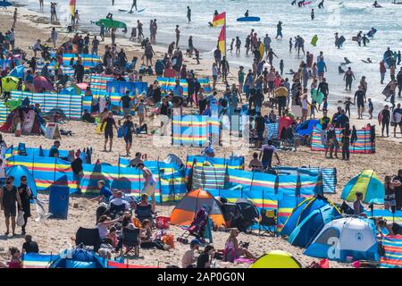Holidaymakers enjoying themselves on Fistral Beach in Newquay in Cornwall.
