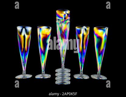 Colourful stress patterns in hard plastic, revealed by imaging between two crossed polarising filters showing a pattern of plastic wine glasses Stock Photo