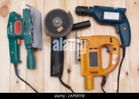 Set of construction tools on a wooden background. Stock photo out of focus assortment of electric tools. Stock Photo