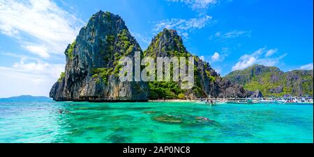 Tropical Shimizu Island and paradise beach, El Nido, Palawan, Philippines. Tour A Route. Coral reef and sharp limestone cliffs. Stock Photo