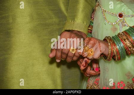 Bride and groom show their hands with engagement rings. Stock Photo