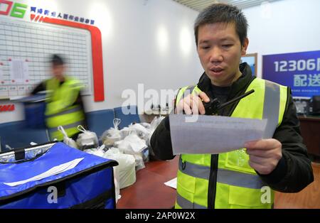(200120) -- NANCHANG, Jan. 20, 2020 (Xinhua) -- Deliveryman Ma Tao checks the train's arriving time at Nanchang West Railway Station in Nanchang, capital of east China's Jiangxi Province, Jan. 18, 2020. Ma Tao, 45, is a deliveryman of on-demand food delivery service for high-speed trains. During the Spring Festival travel rush, Ma travels to and fro between the food distribution center and the platforms to deliver warm meals to the passengers aboard the train.   As a food deliveryman, Ma Tao has to act rapidly and accurately. He must keep train and carriage numbers of the clients in mind so th