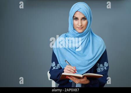Muslim female student learning at home Stock Photo