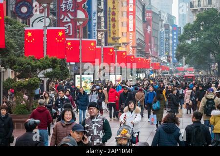 Tourists crowd the Nanjing Road shopping street ahead of the Chinese New Year or Spring Festival in Shanghai, China on January 18th, 2020. Stock Photo