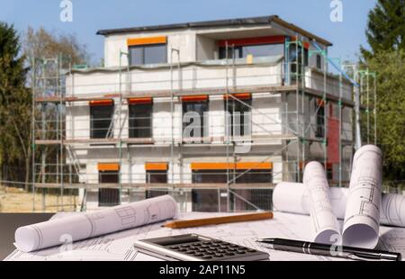 Construction plans with calculator and a shell in the background | usage worldwide Stock Photo