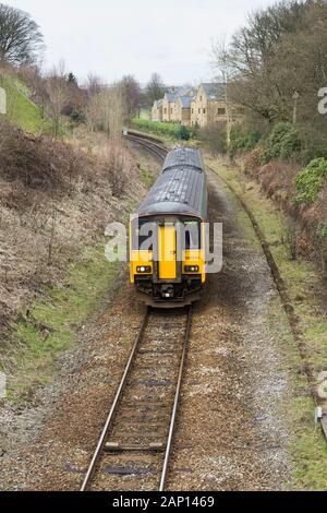 Northern Rail class 150 Sprinter local passenger train passing the derelict Turton and Edgworth staton the Blackburn - Bolton railway line. Stock Photo