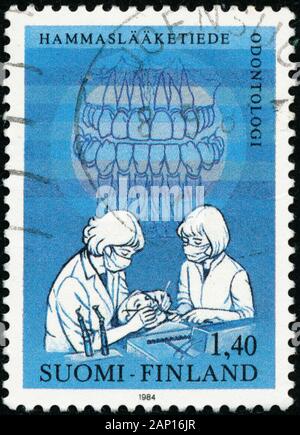 POLTAVA, UKRAINE - January 20, 2020. Vintage stamp printed in Finland circa 1984 show International Dentist congress Stock Photo