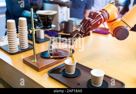 automatic arm preparing coffee in coffee machine Stock Photo