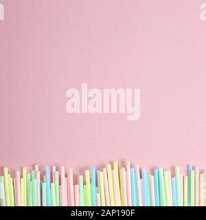 Pastel color straws on pink background Stock Photo