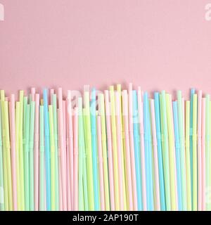 Pastel color straws on pink background Stock Photo