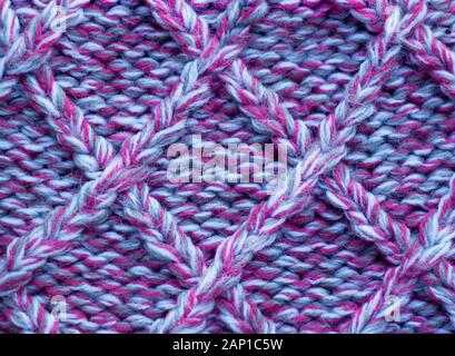 Knitting  in pink and gray melange.Knitted background. Knitted texture. Knitting pattern from wool. Stock Photo